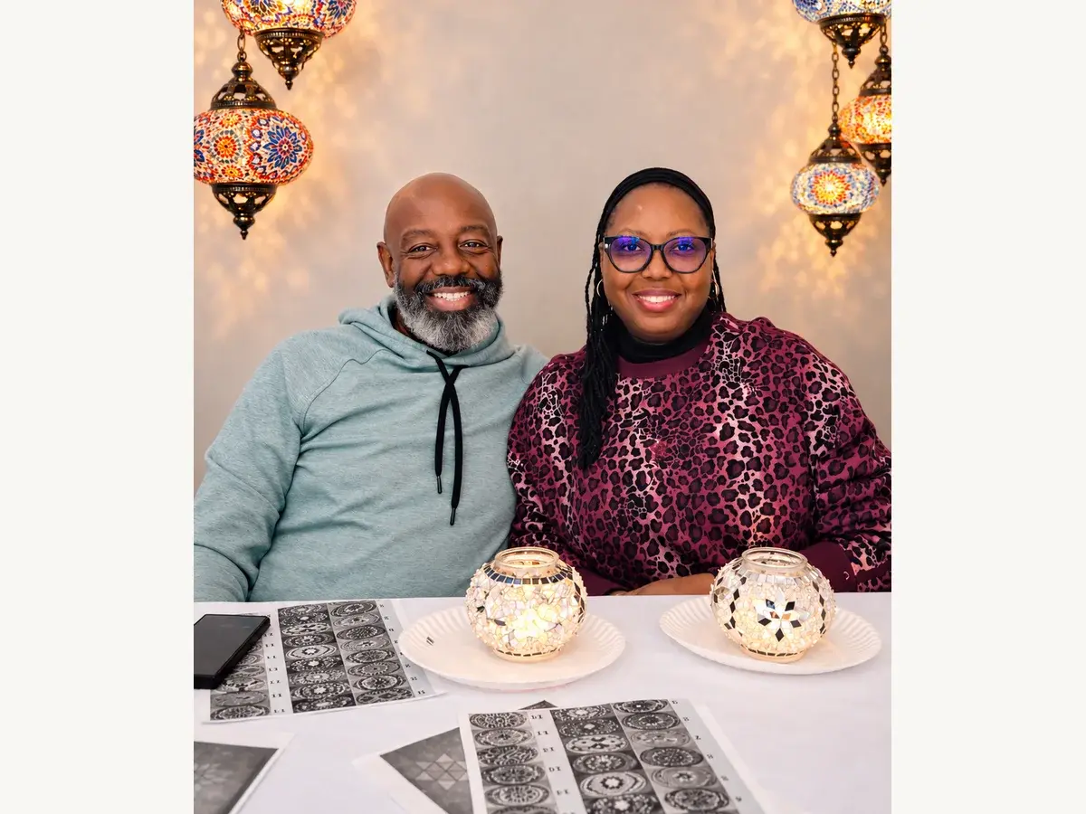 Two workshop guests with colorful mosaic lamps