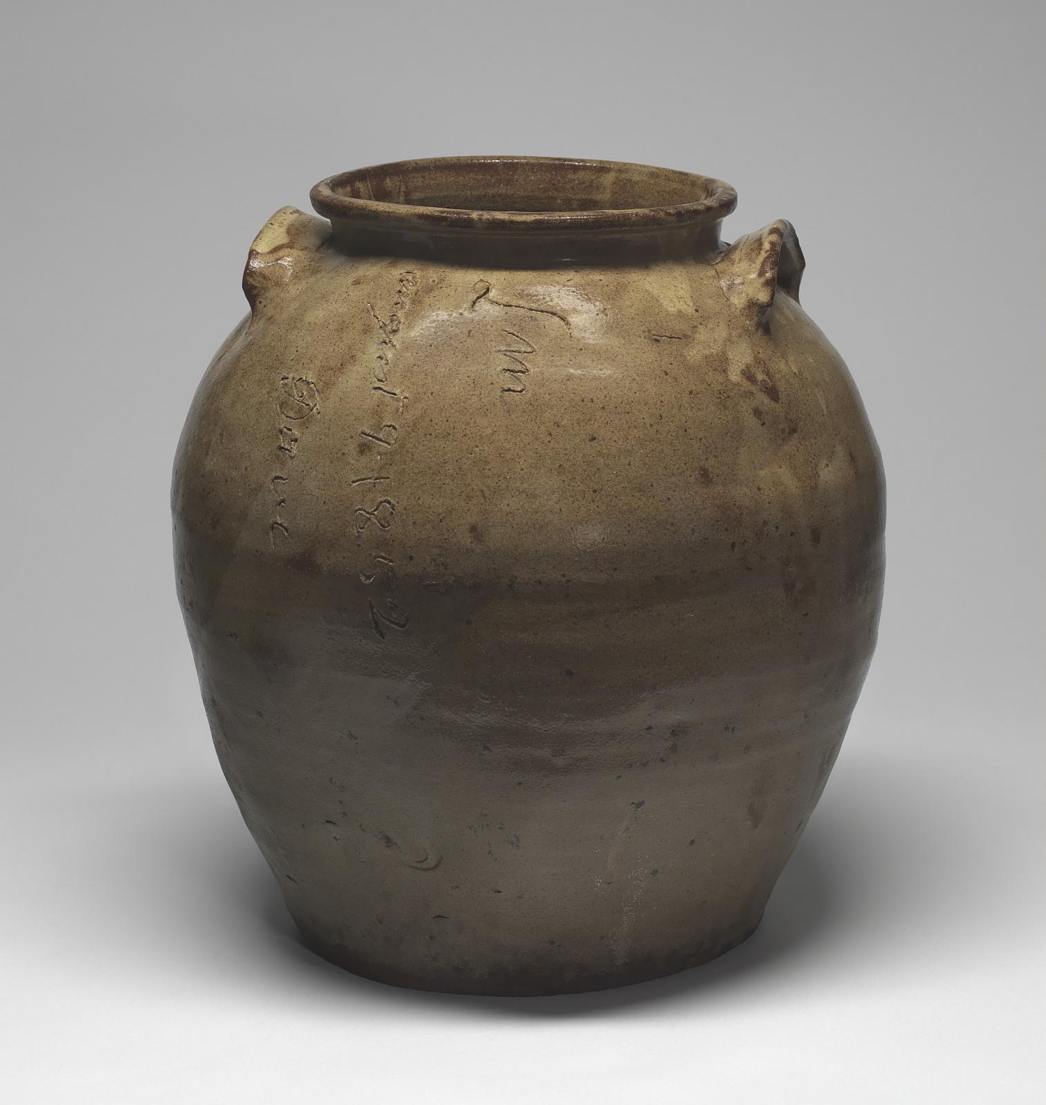 Brown glazed stoneware storage jar with two small handles and David Drake’s incised signature and date, August 9, 1852.